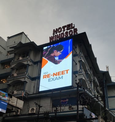 a large billboard board with a large advertisement on the side of a building