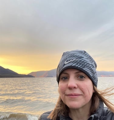 Amy McArdle in a hat by the Hudson River
