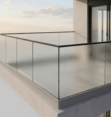 Modern high-rise apartment balcony featuring sleek glass railings and a minimalist concrete design.