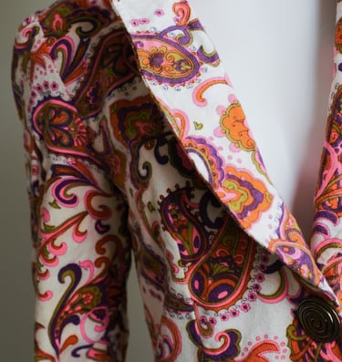 a woman's jacket with a colorful paisley pattern
