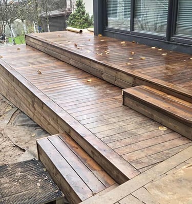 a wooden deck with a bench and a bench