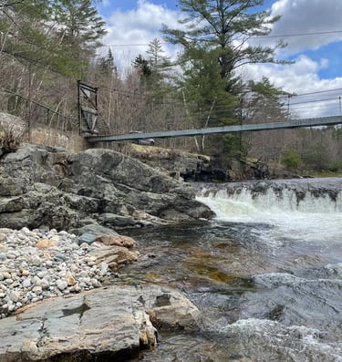 a bridge over a river with a dam