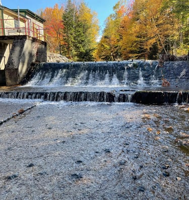 a waterfall in the middle of a river