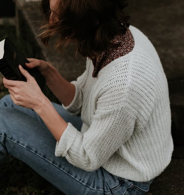 A lady grasping a Bible