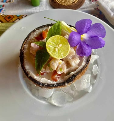 a coconut shellfish dish with flowers on ice