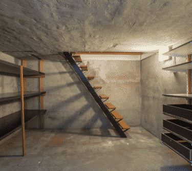 a staircase leading to a basement with a staircase leading up to a second floor