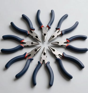 A meticulous arrangement of carbon steel jewelry pliers and cutting tools with dark navy blue rubberized handles, laid flat on a pristine light gray surface under clean bright studio illumination.