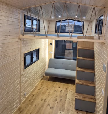 Tiny house living place with staircase and loft