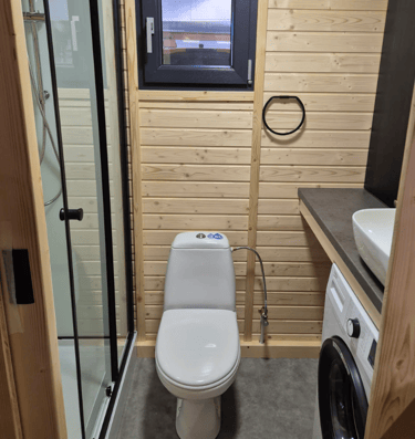 Tiny house bathroom shower, toilet with washing machine