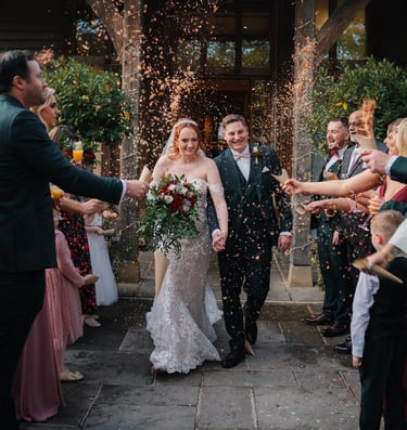 Friends cheering during wedding celebration in Leeds – natural wedding photography by The Wedding Ed