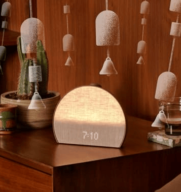 Hatch Restore 3 sunrise alarm clock with glowing light.