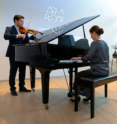 a man and woman playing a piano and violin