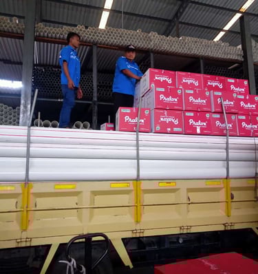 two men standing on a truck with boxes fittings pralon knee pipa pvc 