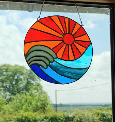 a sun catcher with a sun shining through the window