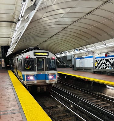 a MBTA blue line train pulling into a aquarium station