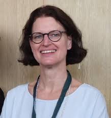 a woman in glasses and a white shirt