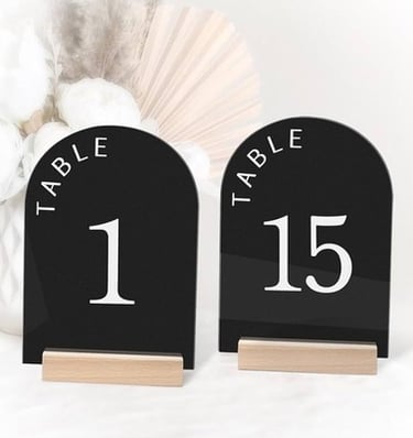 Black acrylic table numbers 1 and 15 with wooden bases.