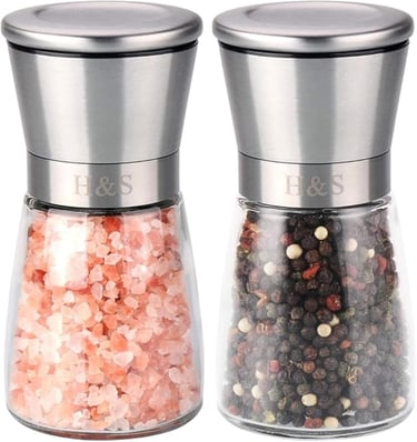 a couple of salt shakers with pink and white salt