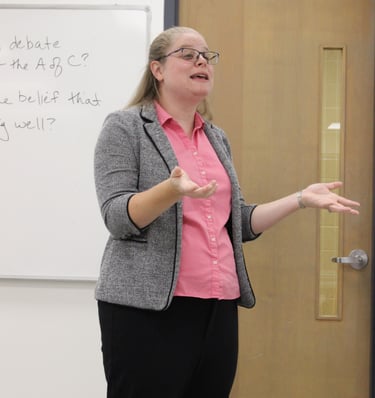 Dr. Hooton at the front of a classroom lecturing during a US History survey course.