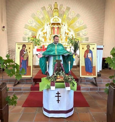 An Orthodox priest in green vestments stands at the altar during a traditional church service.
