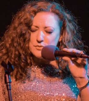 Close-up of Singer Nancy Erickson Lamont's expressive face as she sings into the microphone