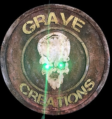 a green light shining through a grave stone plaque