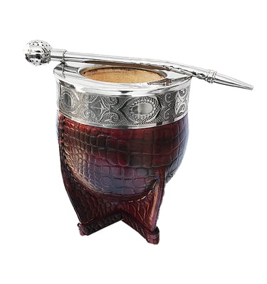 Handcrafted leather-wrapped yerba mate gourd with silver rim and bombilla straw.