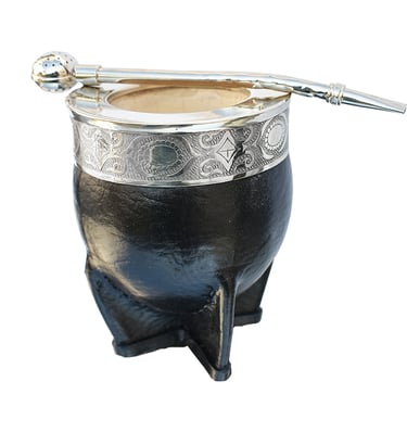 Handcrafted black leather yerba mate gourd with an ornate silver rim and a metal bombilla straw.