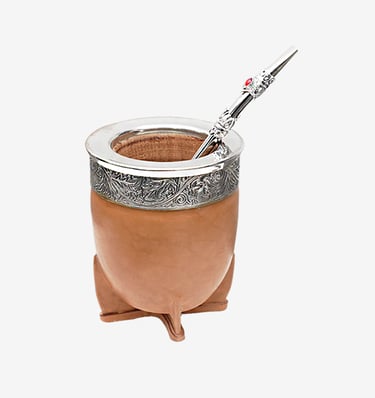 Traditional Argentine leather yerba mate gourd with ornate silver rim and bombilla straw.
