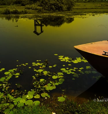 Picture of a lake and a boat whose front part is only seen.