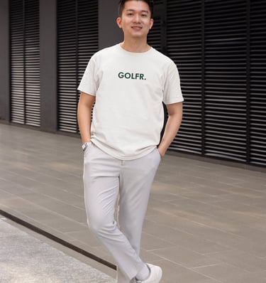 a man in a white shirt and grey pants
