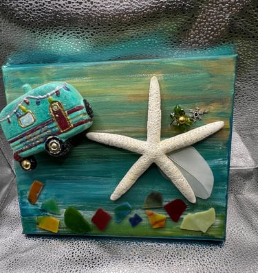 Handmade mixed media canvas art featuring  a vintage camper, starfish, and colorful sea glass.