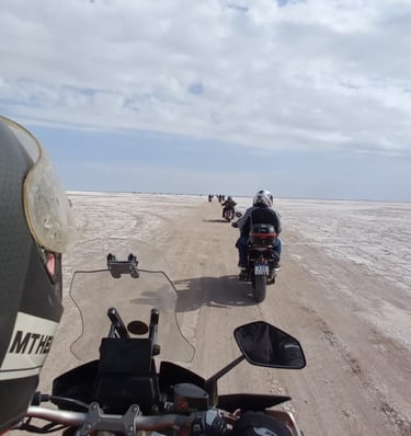 a person riding a motorcycle on a dirt road