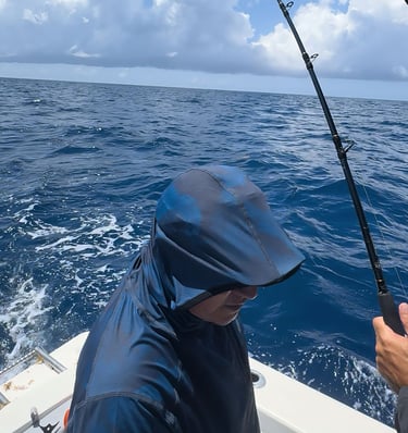 a man fishing in the ocean with a fishing rod