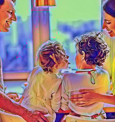 a family of two children sitting at a dinner table