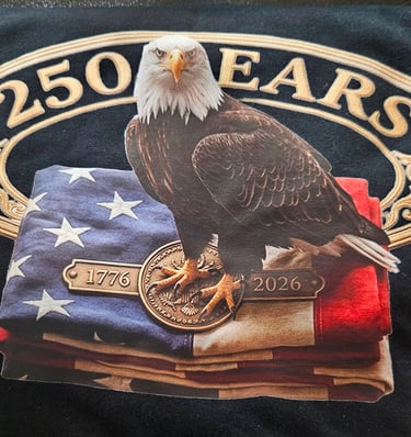 A patriotic 250 years anniversary t-shirt featuring an American bald eagle perched on a folded flag.
