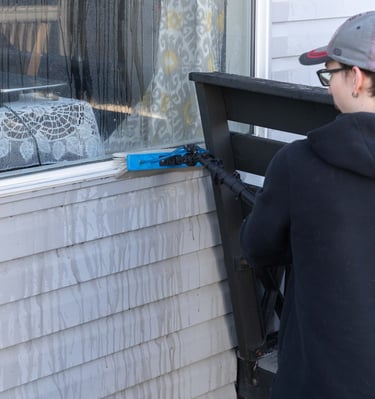 Man Cleaning Window Frame