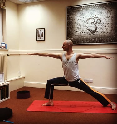 a man is doing yoga exercises on a red carpet