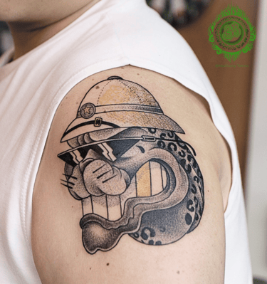 New traditional tattoo of a leopard with sunglasses and a hat on the upper arm