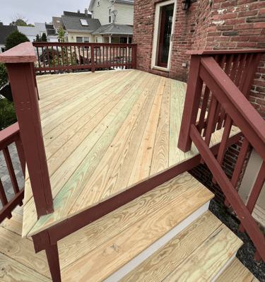a wooden deck with a wooden deck and stairs