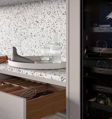 a kitchen with a drawer full of utensils and a knife