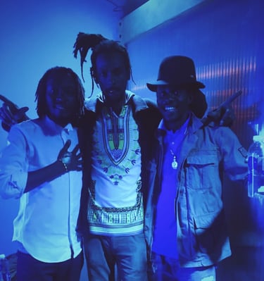 three men standing next to each other in a room