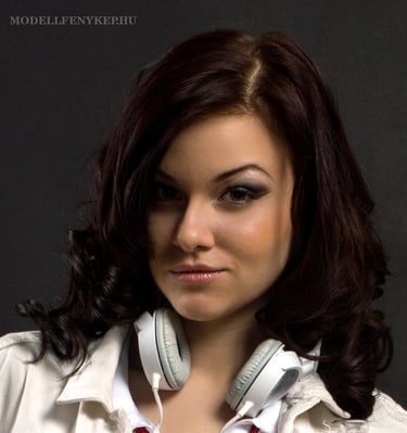 a beautiful woman with headphones on a black background DJ photoshoot