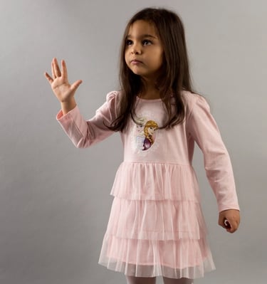 a young girl in a pink dress and tight socks