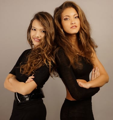 two women in black dresses posing for a professional photoshooting