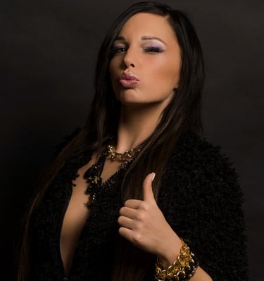 a beautiful woman with long hair and a black jacket wearing necklace