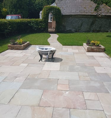 a patio with a table and chairs in the yard