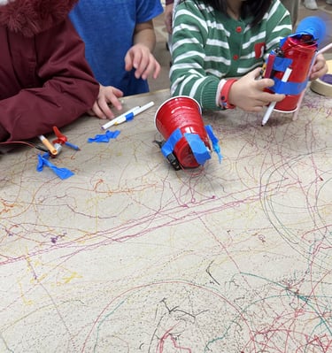 a young child is testing their STEMVillage drawing bot