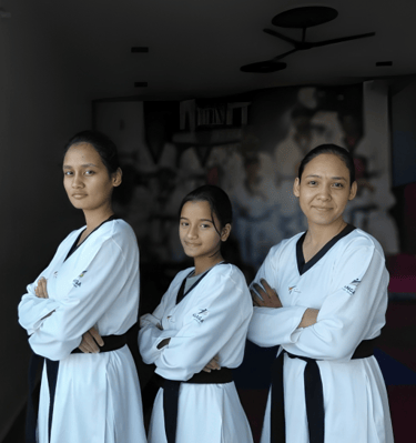 three women in white uniforms standing in a hallway
