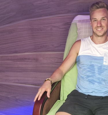 A man relaxing inside the Harmonic Egg for bio-energy and sound frequency therapy.